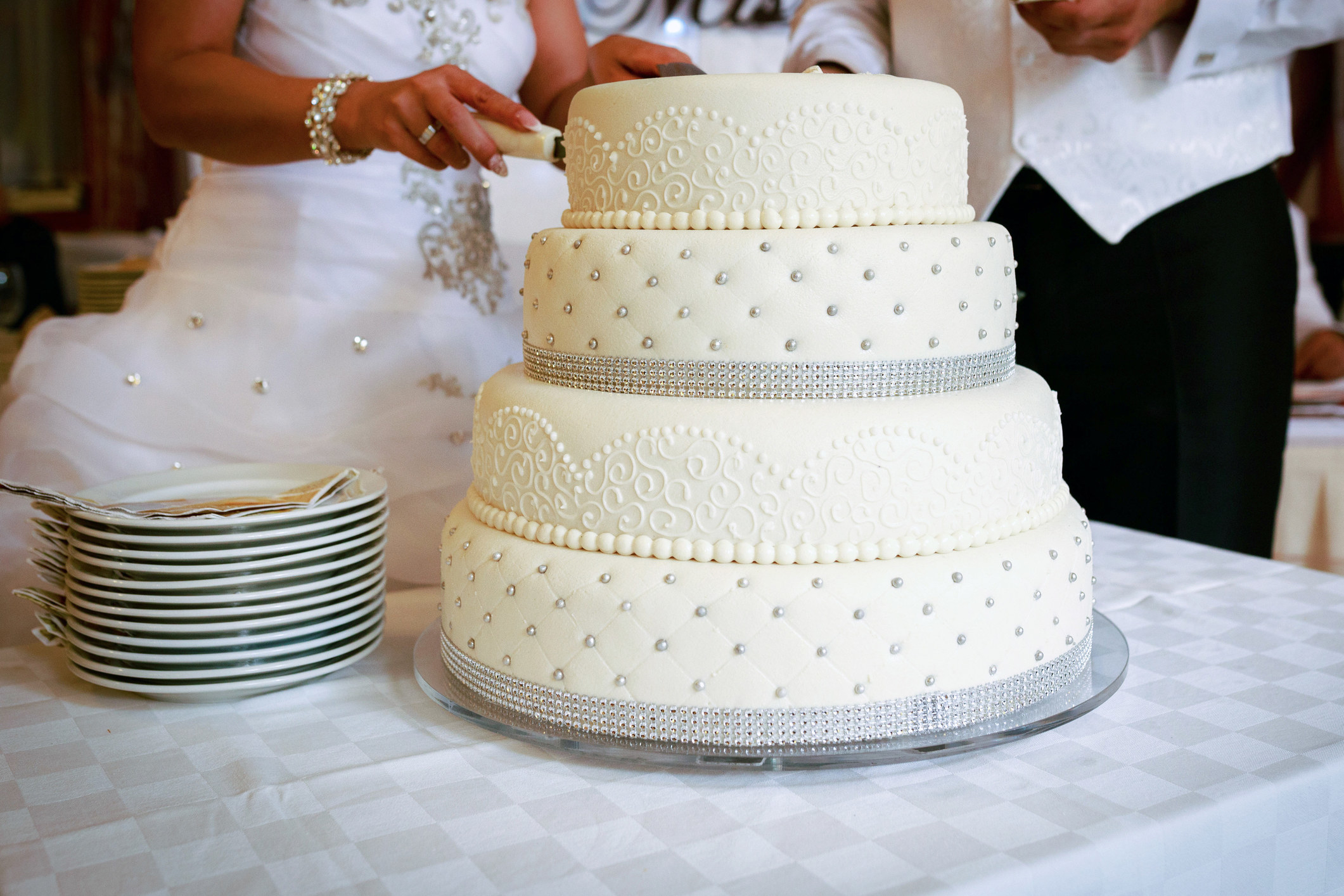 Bride and groom cutting a tiered wedding cake