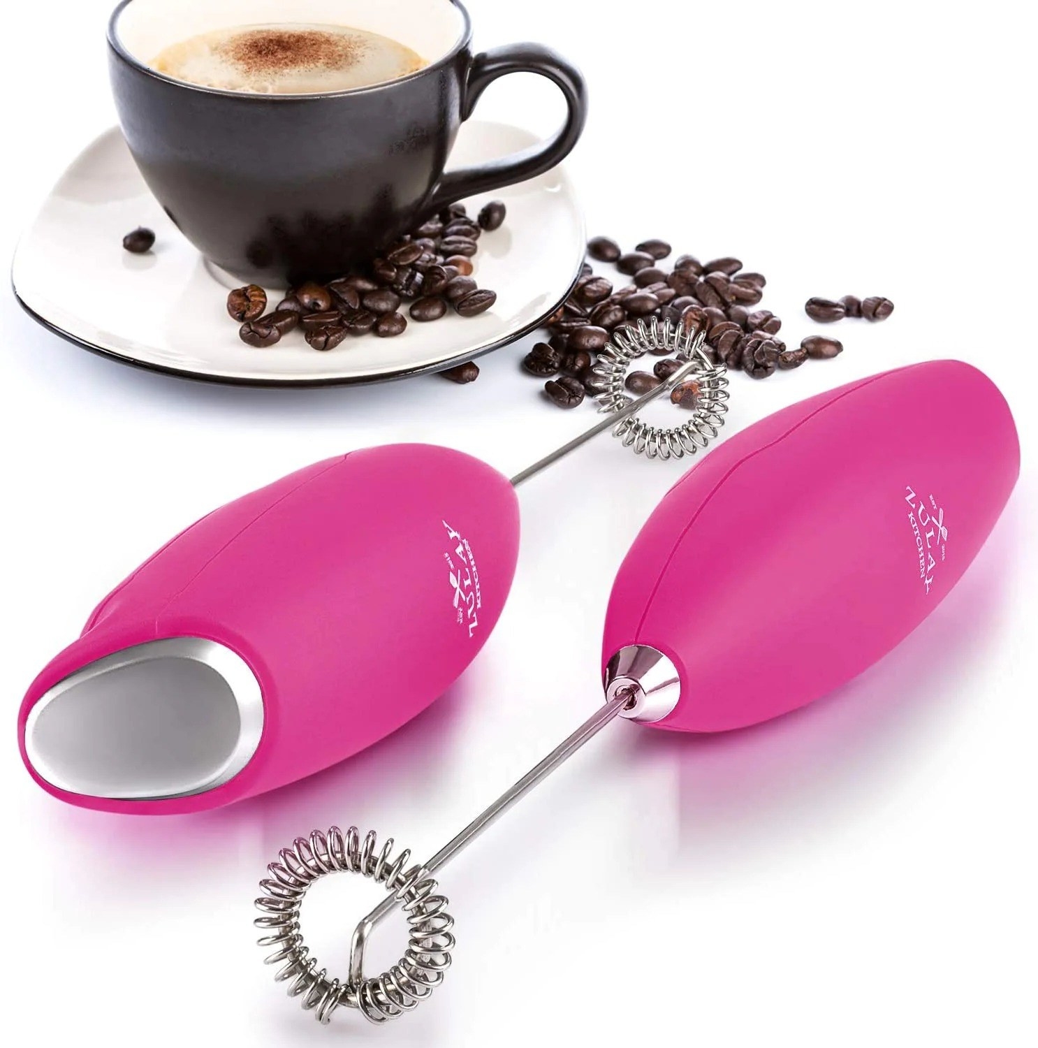 the pink frother next to a cup of coffee and beans