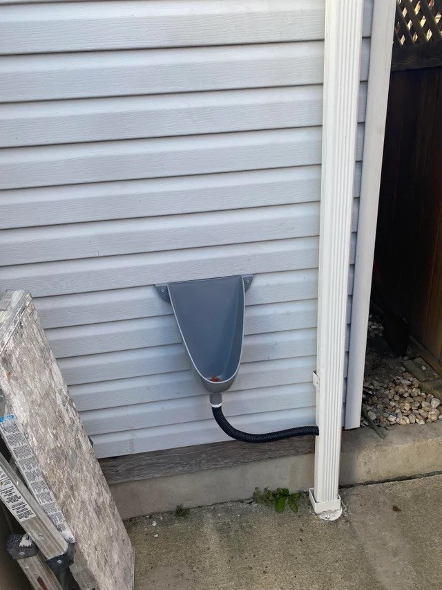 a funnel and hose attached to a garage door