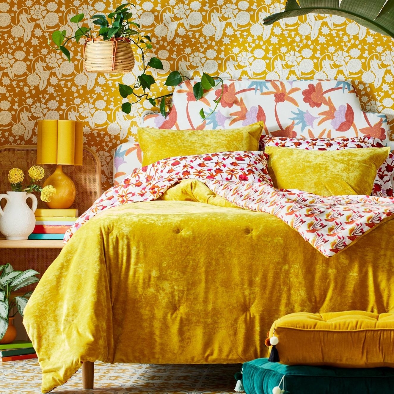 The comforter and shams in yellow on a bed