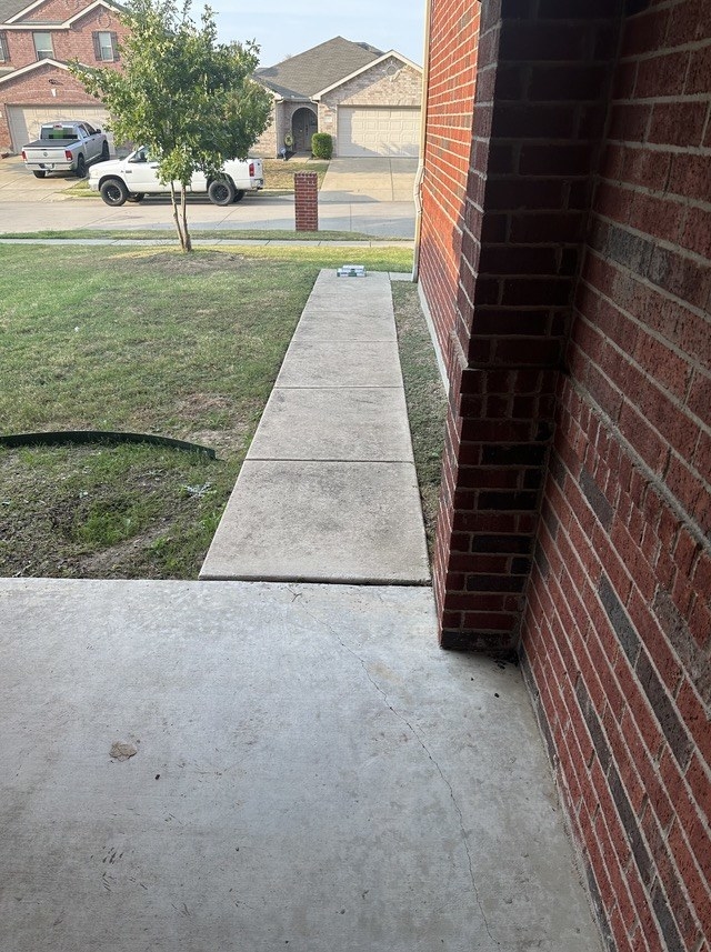 pizzas at the end of a sidewalk to a house