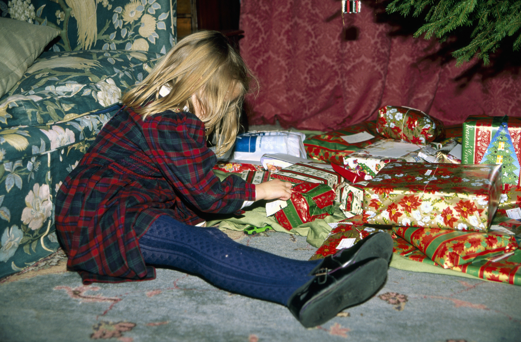 A little girl opening presents