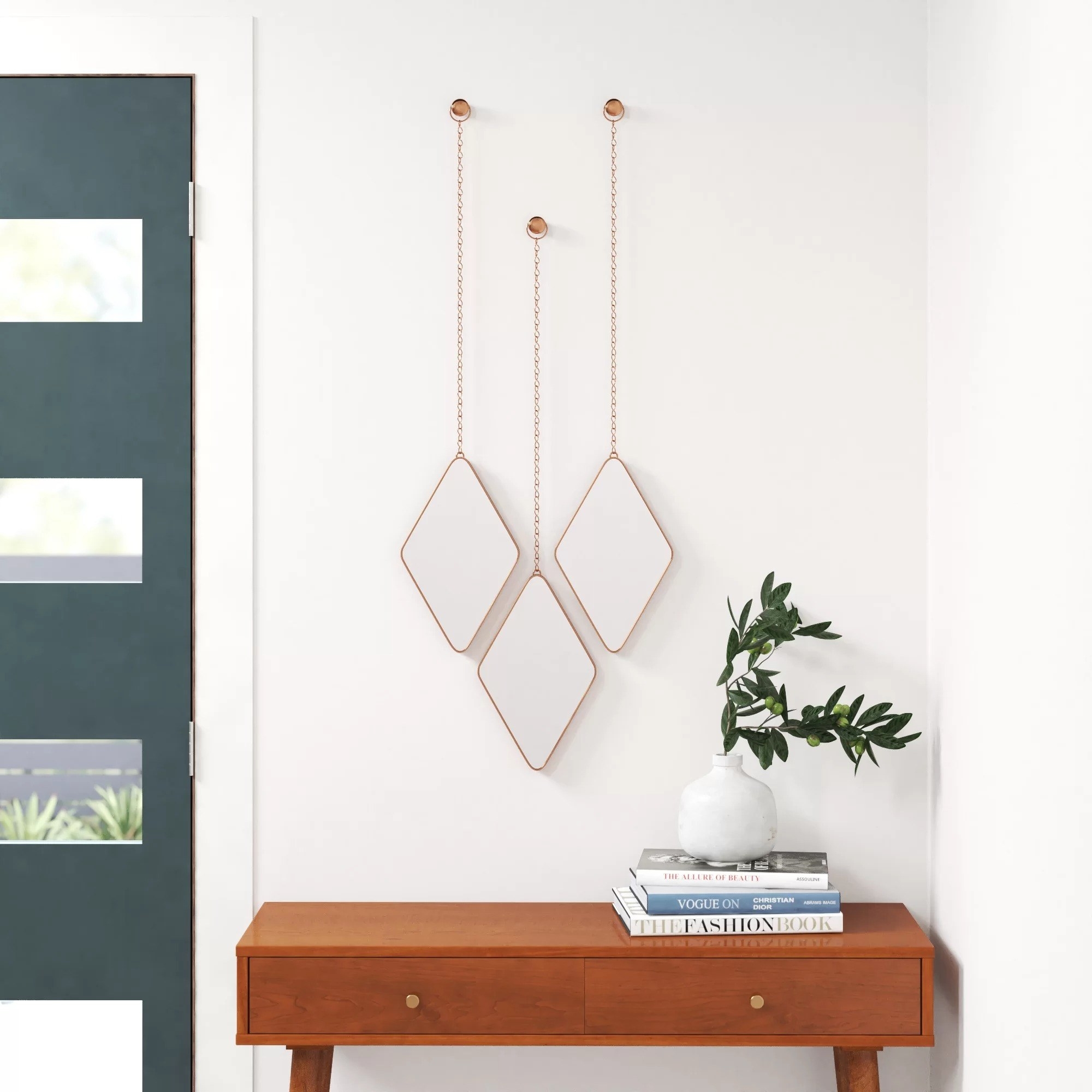 the copper mirrors hanging in an entryway