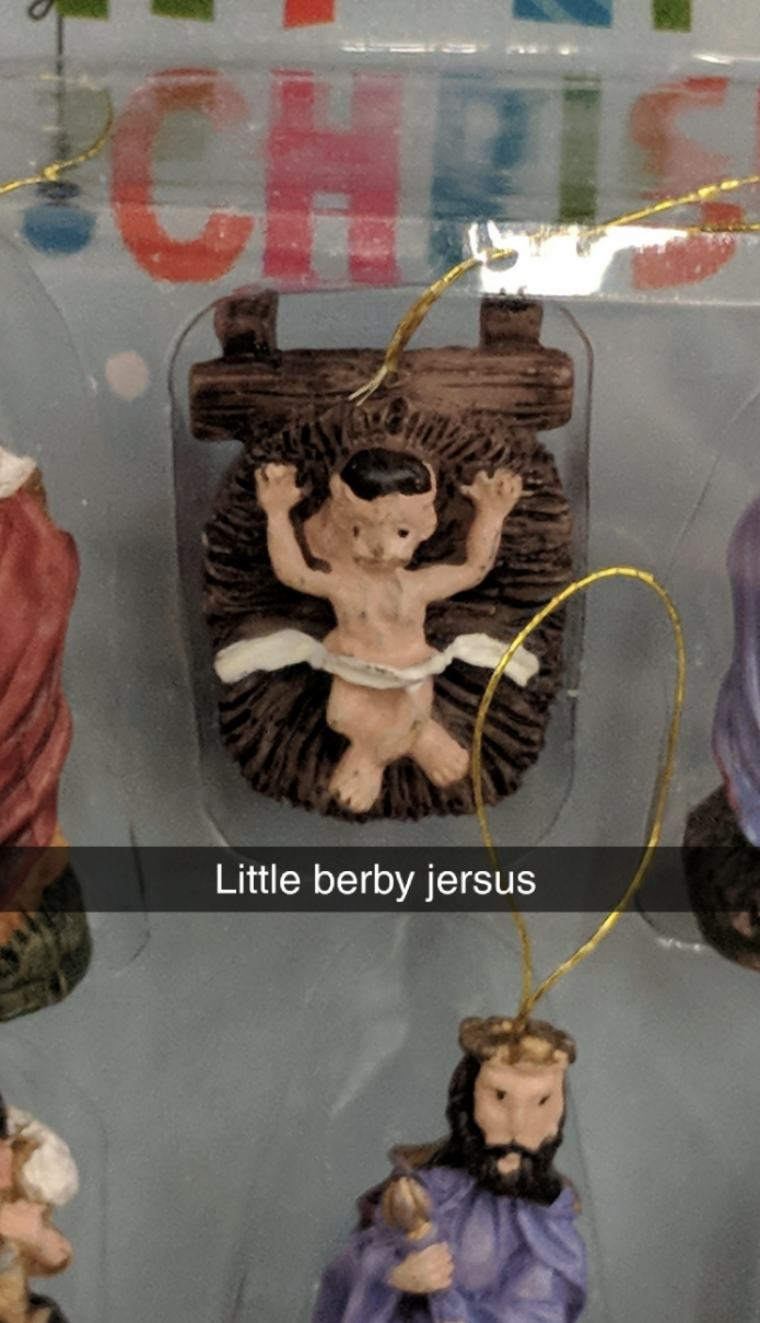 &quot;Little berby jersus&quot; caption with a misshapen doll Jesus with arms raised