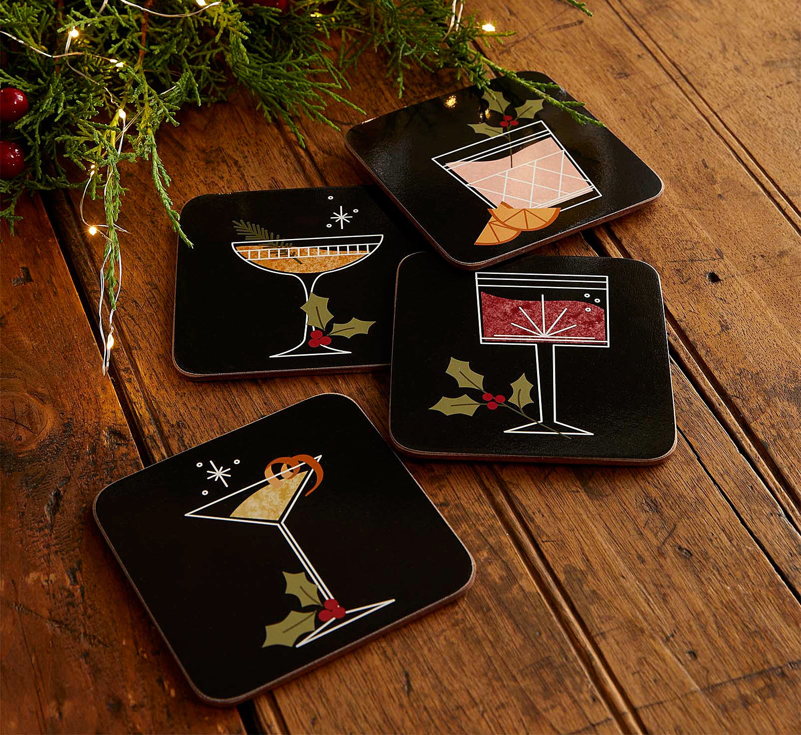 the four coasters on a wooden table