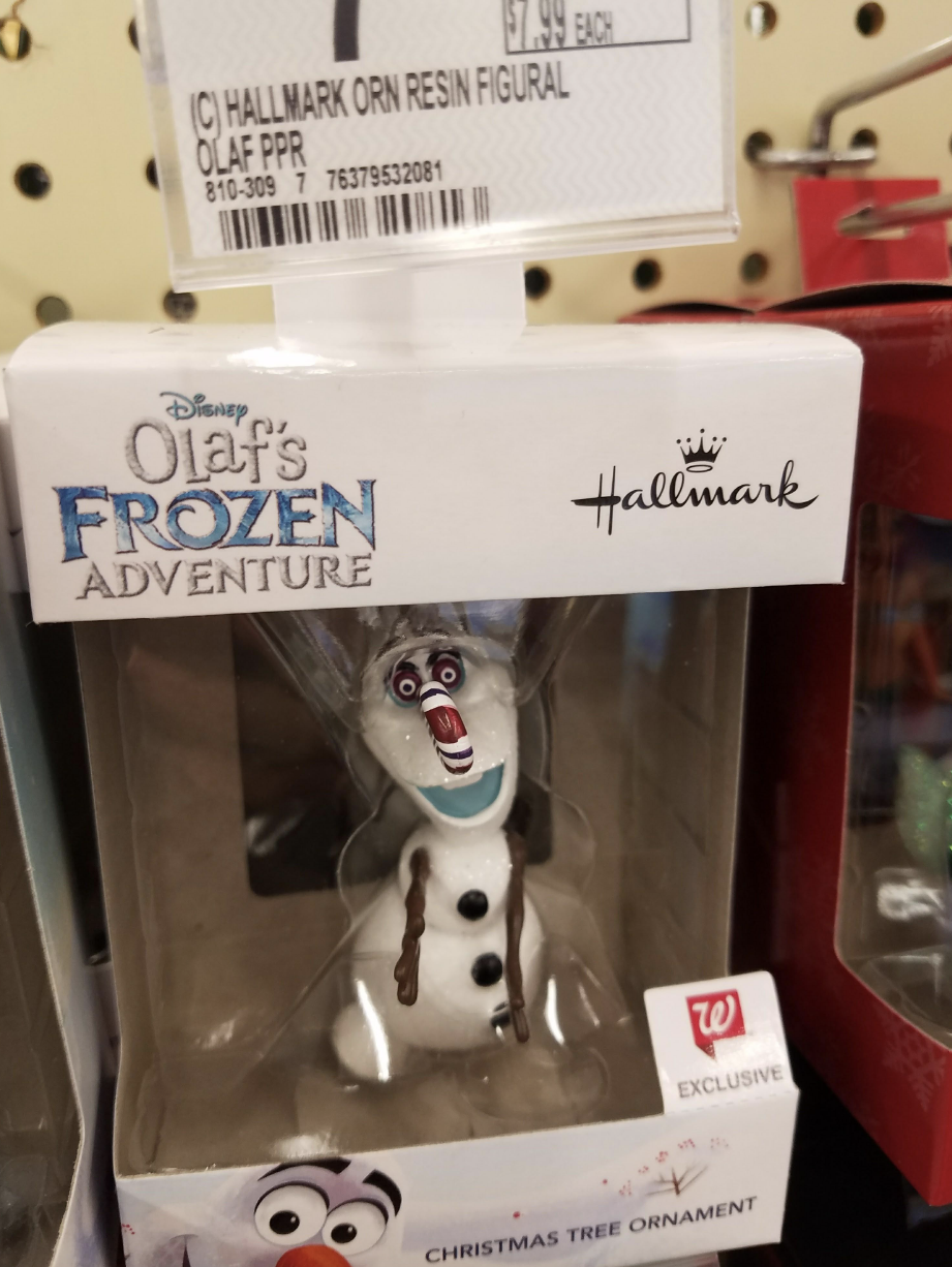 A scary-looking Olaf doll in a box