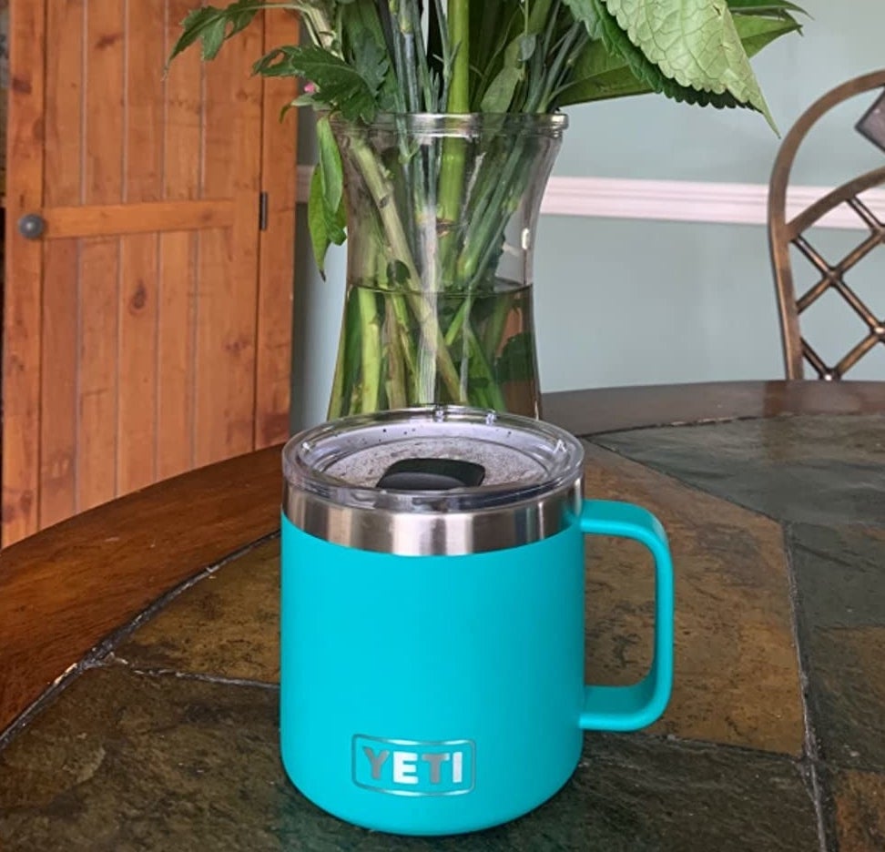 reviewer's bright blue mug with sliding lid