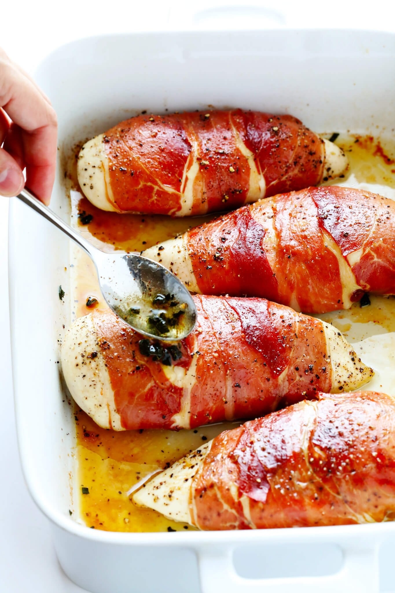 A baking dish of Prosciutto-Wrapped Baked Chicken