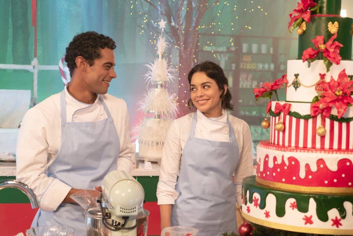 Nick Sagar and Vanessa Hudgens smiling at each other in a kitchen scene from The Princess Switch
