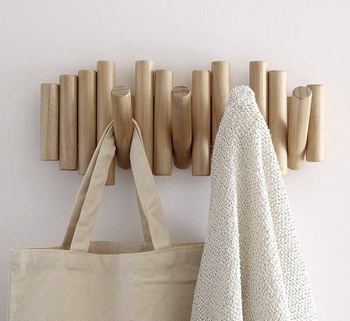 A scarf and a bag hanging from the hooks