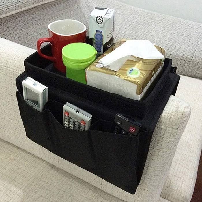 The couch caddy placed across the arm of a couch