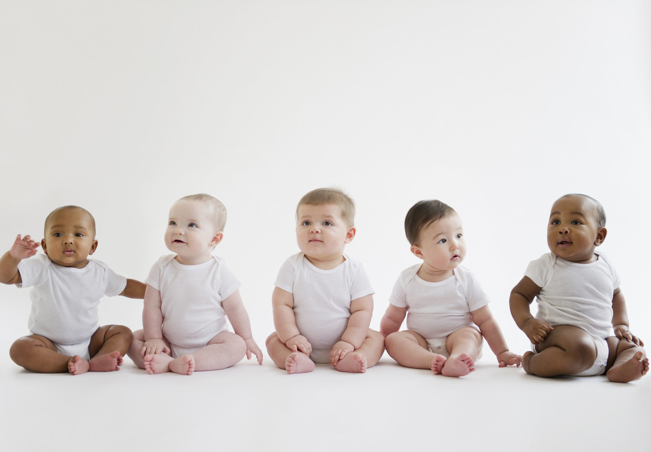 baby boys sitting up in onesies