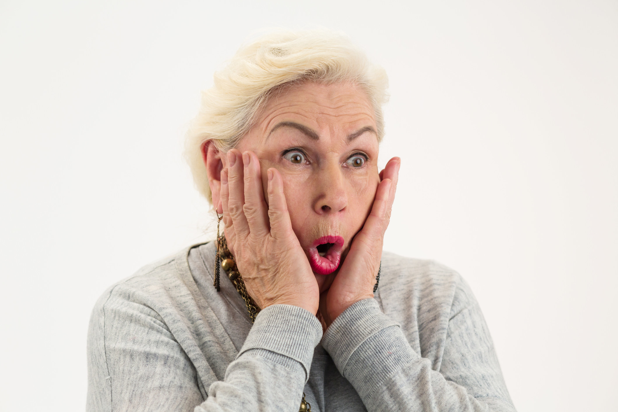 a woman holding her hands to her face