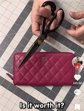 Tanner holding his scissors over a Chanel wallet