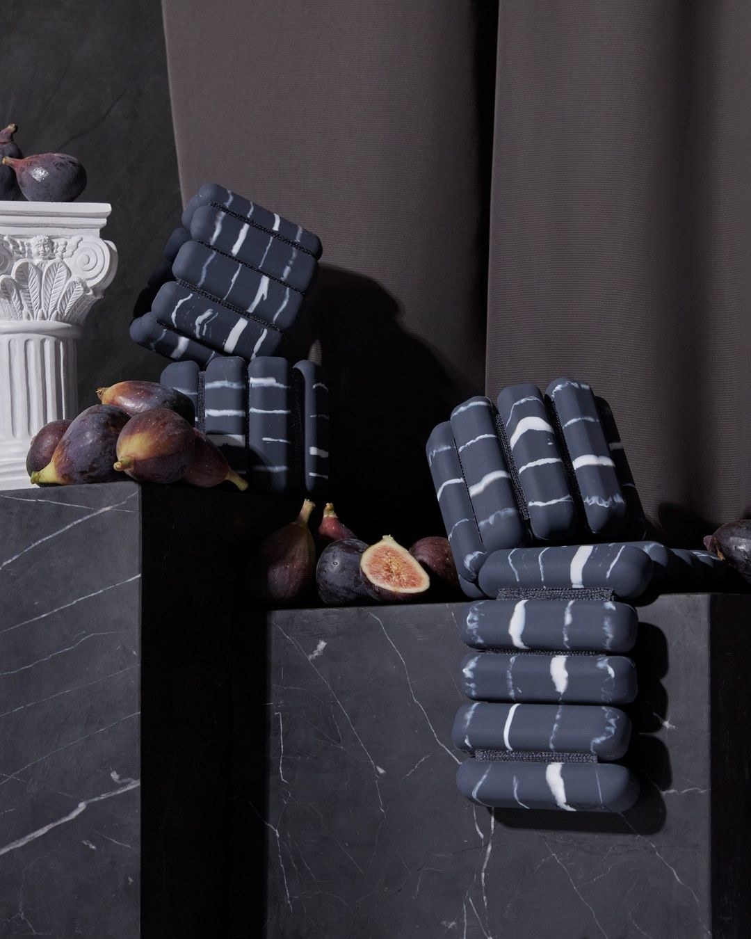 two pairs of the marble patterned bala bangles on large marble cubes