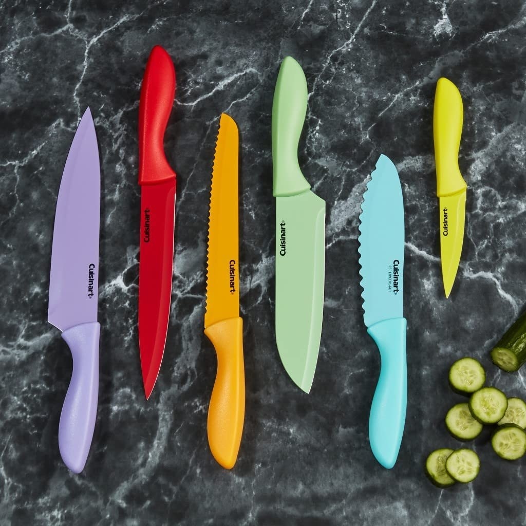a flatlay of the colourful knife set on a marble countertop