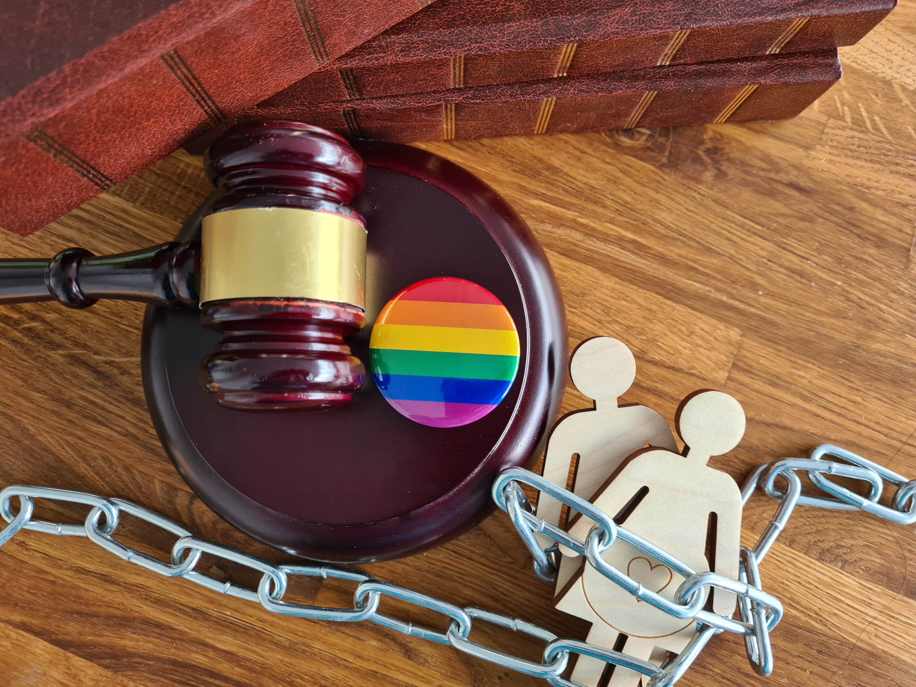 A gavel and Pride Flag button