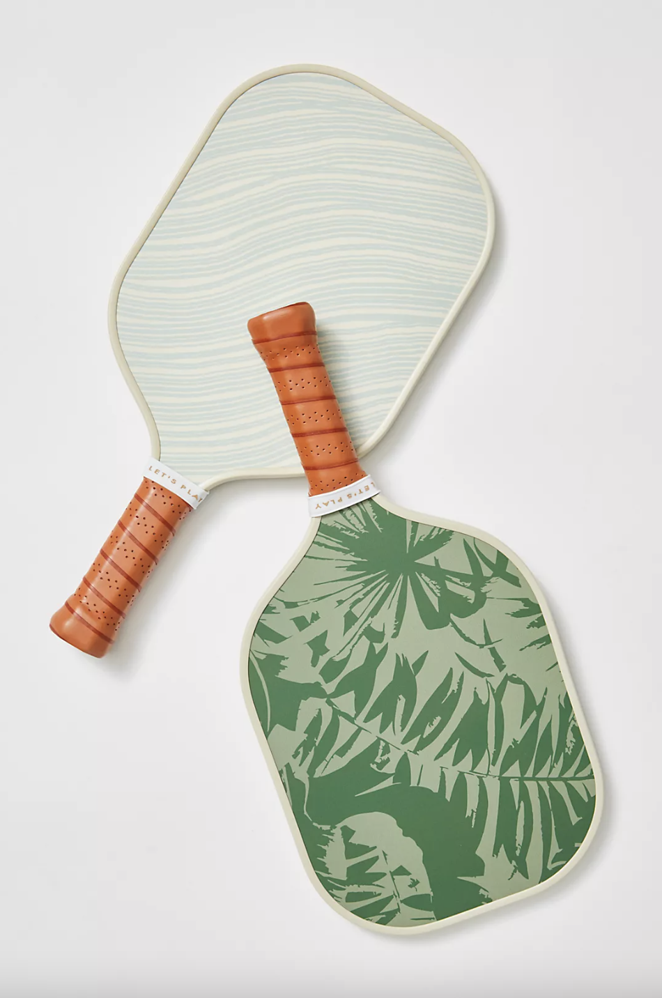 a pair of the chic pickleball paddles arranged aesthetically on a simple background