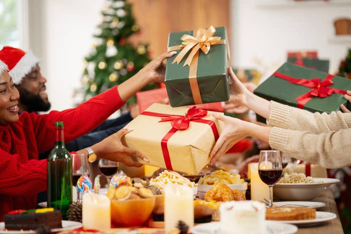 people exchanging gifts from across the table