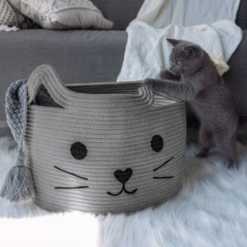 a gray cat basket with a blanket inside