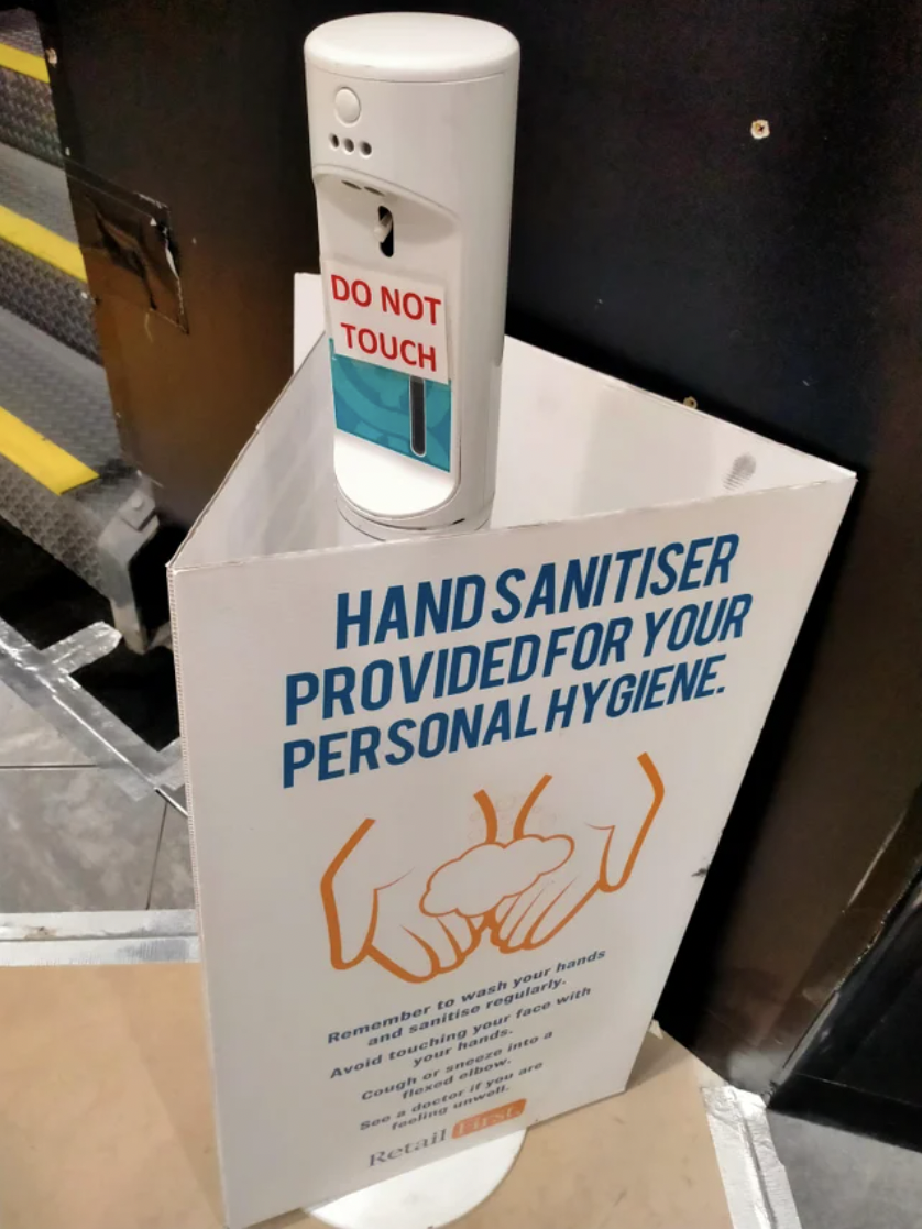 a sign for hand sanitizer that says &quot;do not touch&quot;