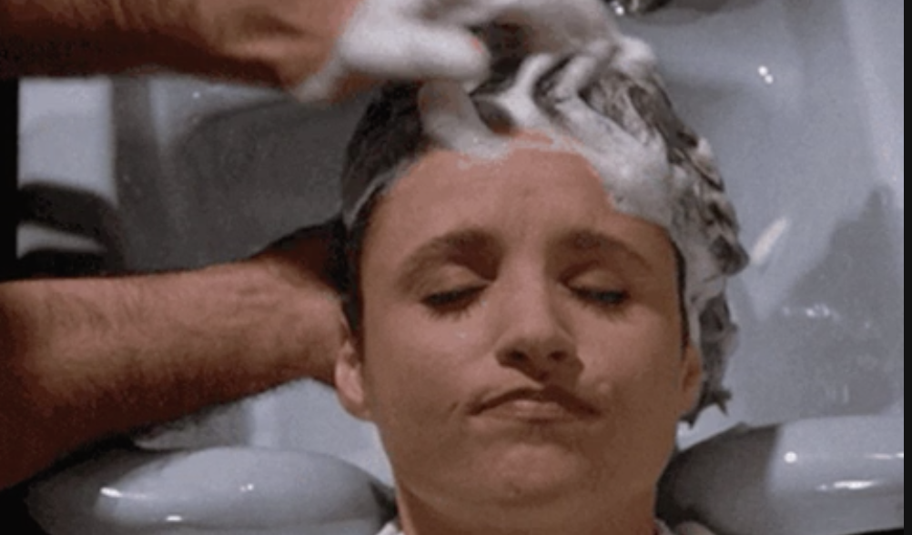 a gif of hair being washed in a sink