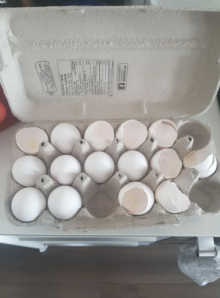 Broken eggs in a carton