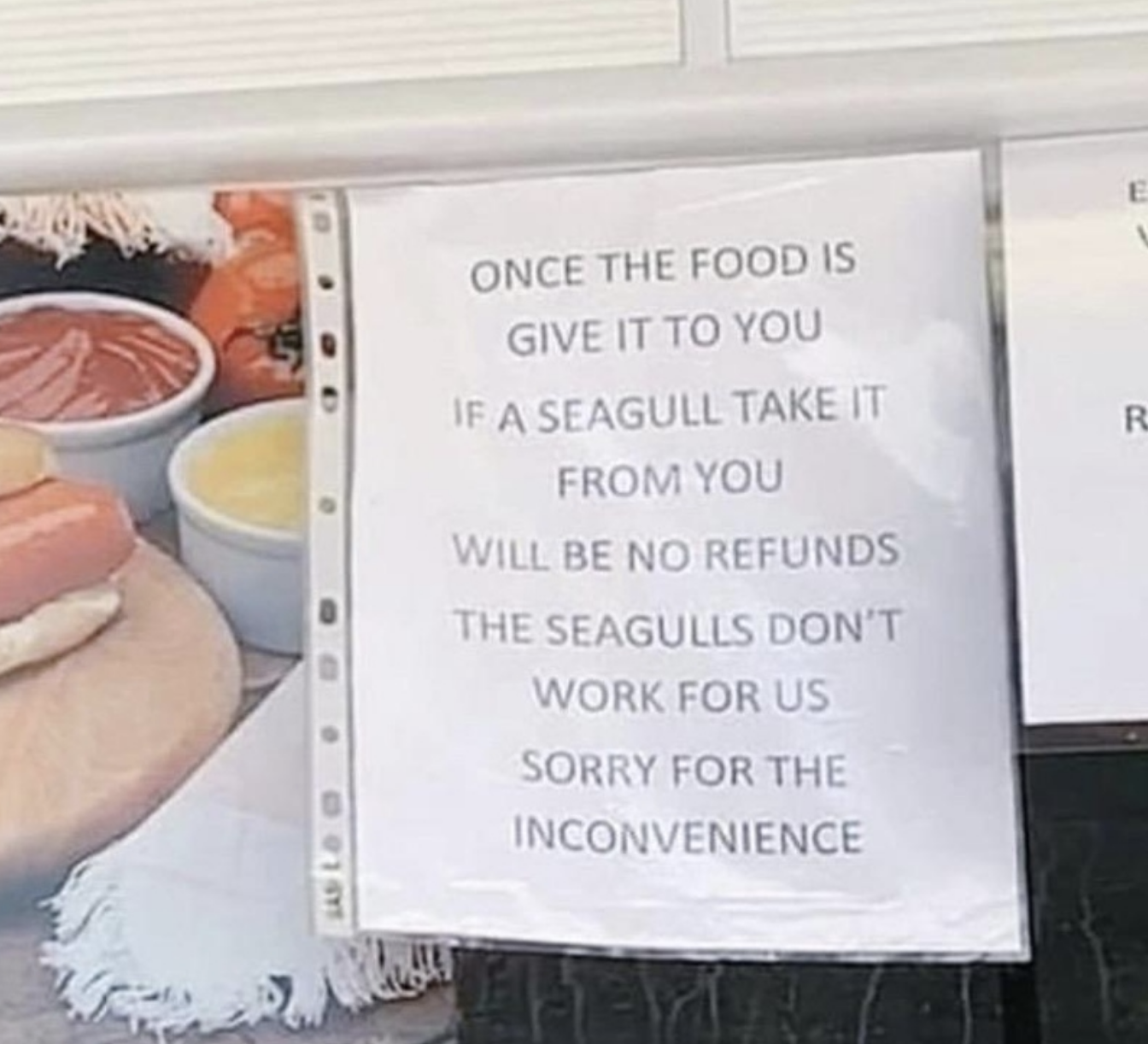 Sign says, Once the food is given to you, if a seagull takes it, no refunds. The seagulls don&#x27;t work for us. Sorry for the inconvenience