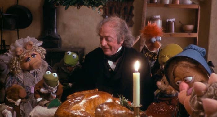 Ebenezer Scrooge surrounded by Muppets in The Muppets Christmas Carol