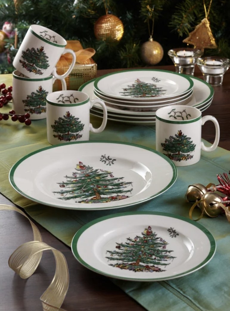 There is a white and green Christmas set with decorated Christmas trees in the middle