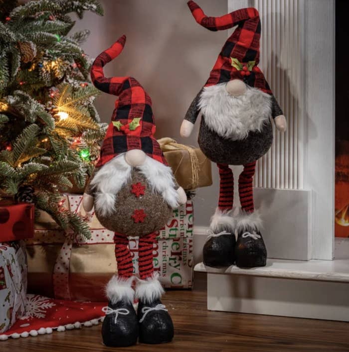There are two gnomes with striped stockings and mistletoe embellishments