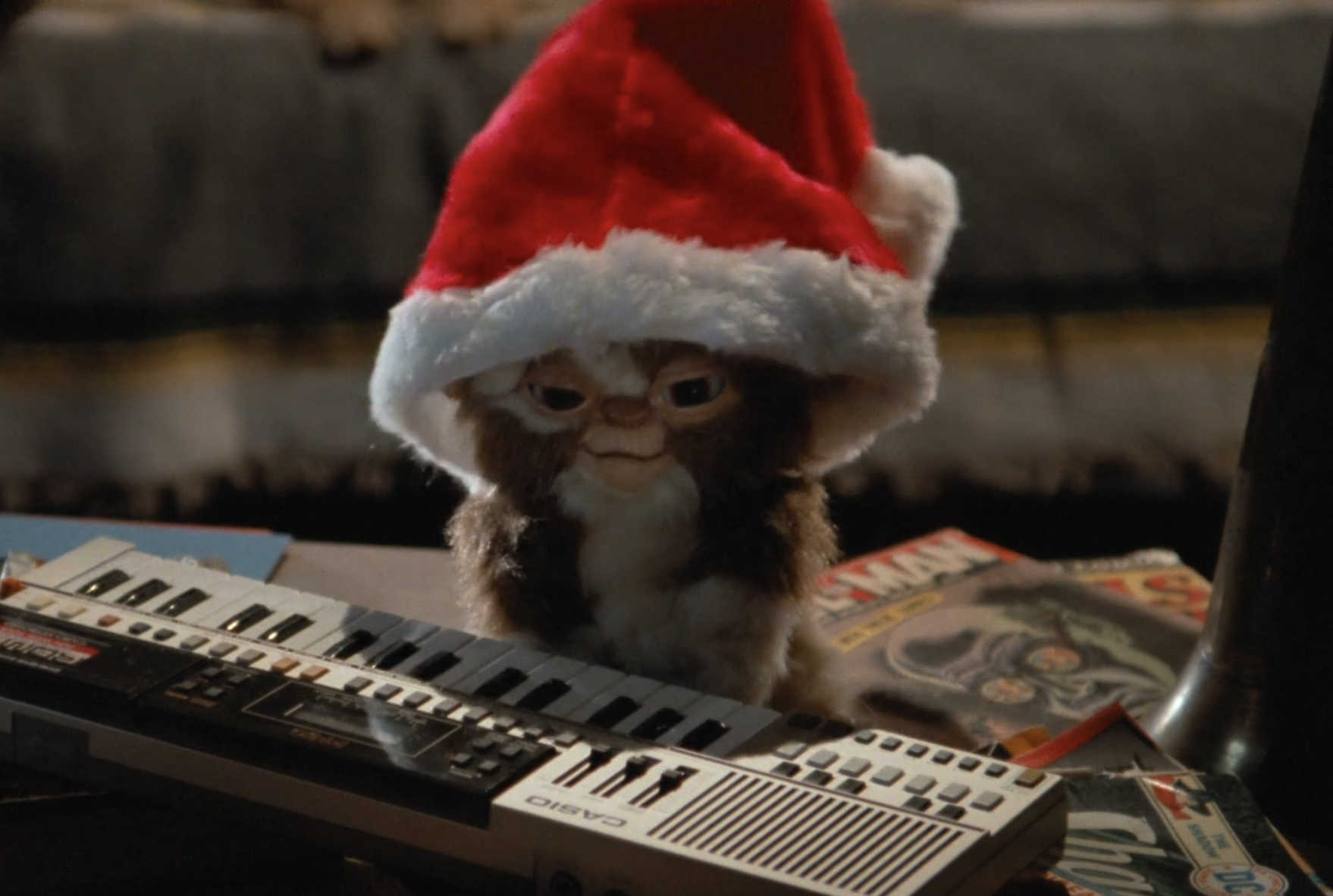 Gizmo from Gremlins wearing a Santa hat