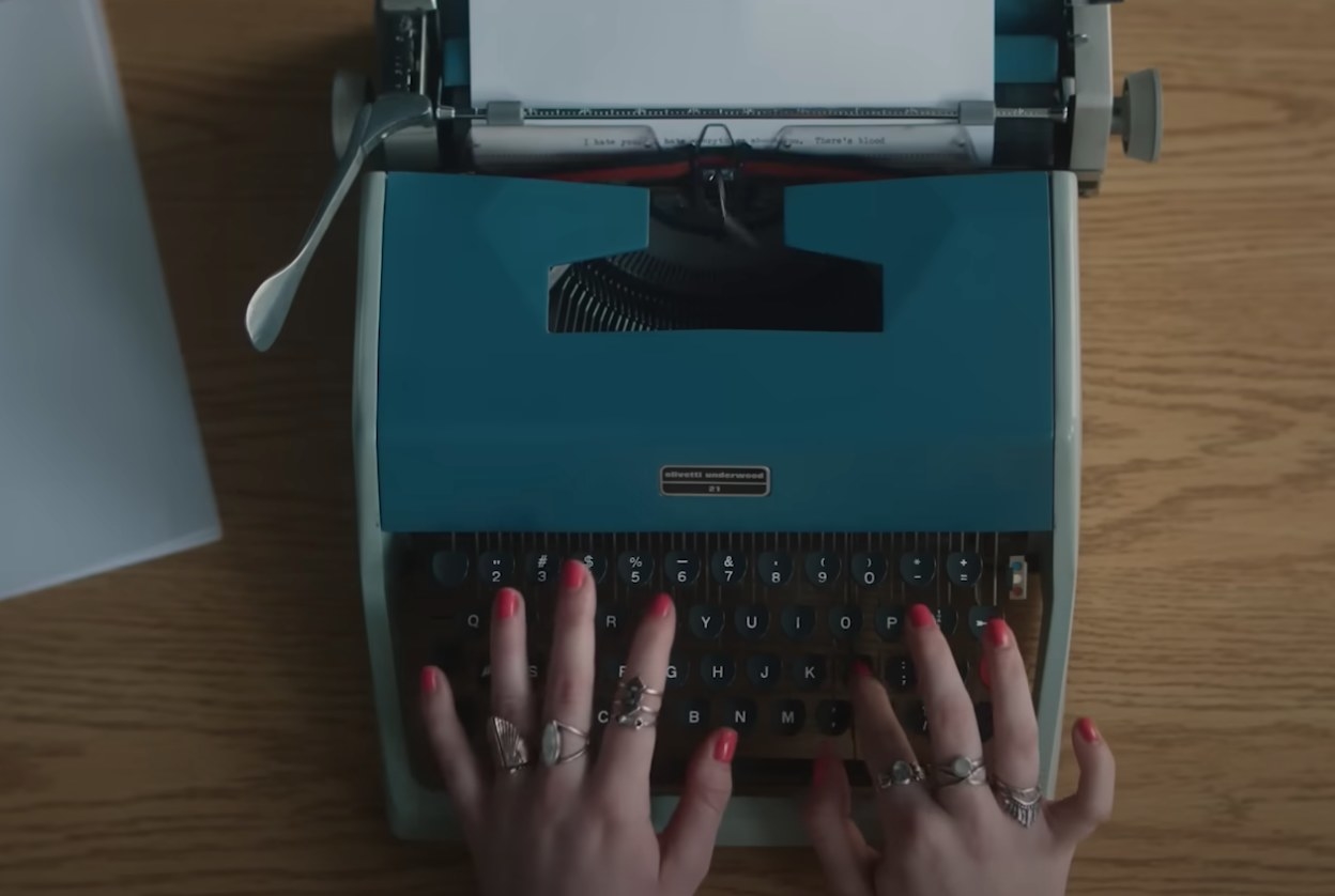 Typewriter being used by female hands