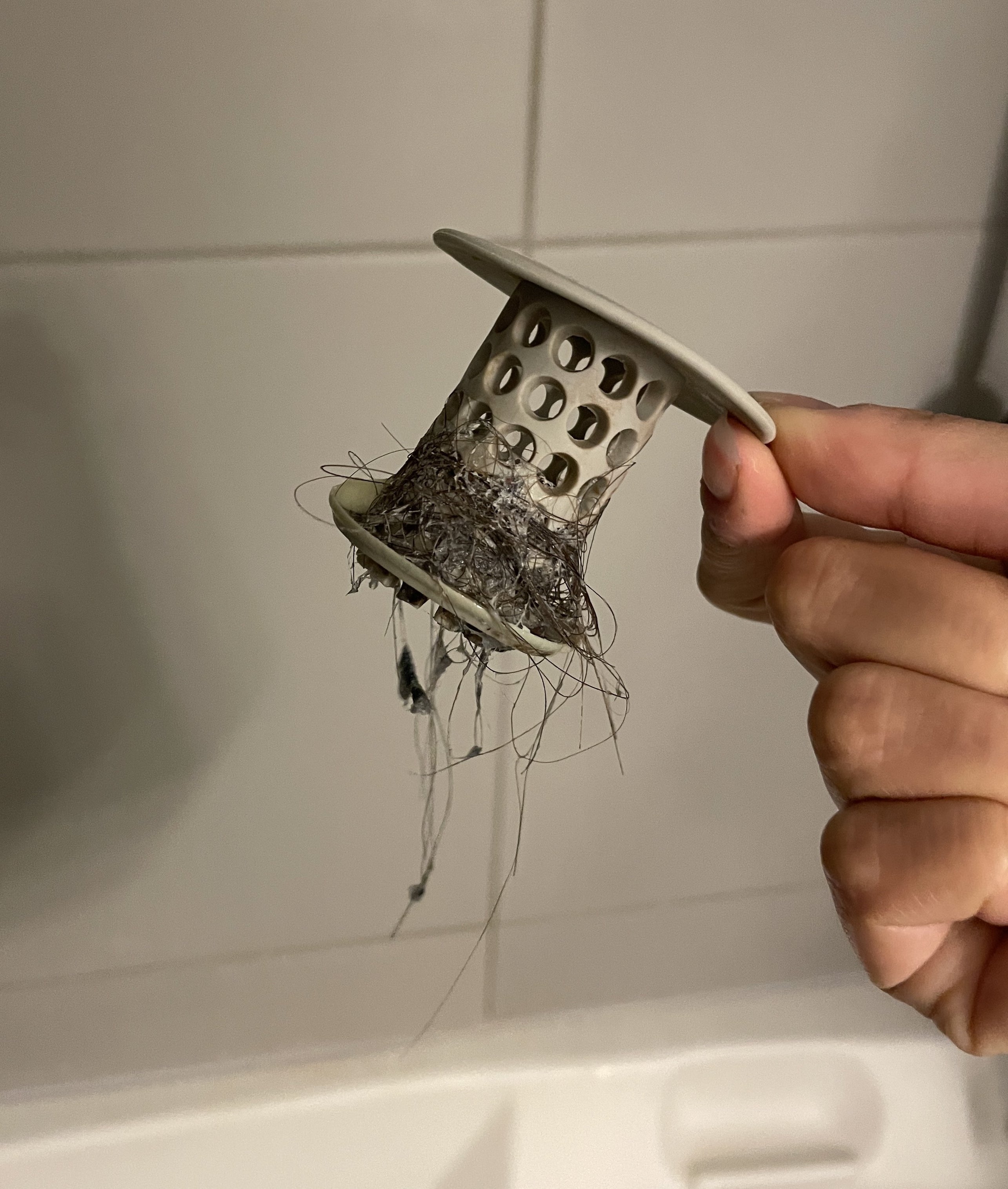 buzzfeed writer holding the tubshroom with hair on it