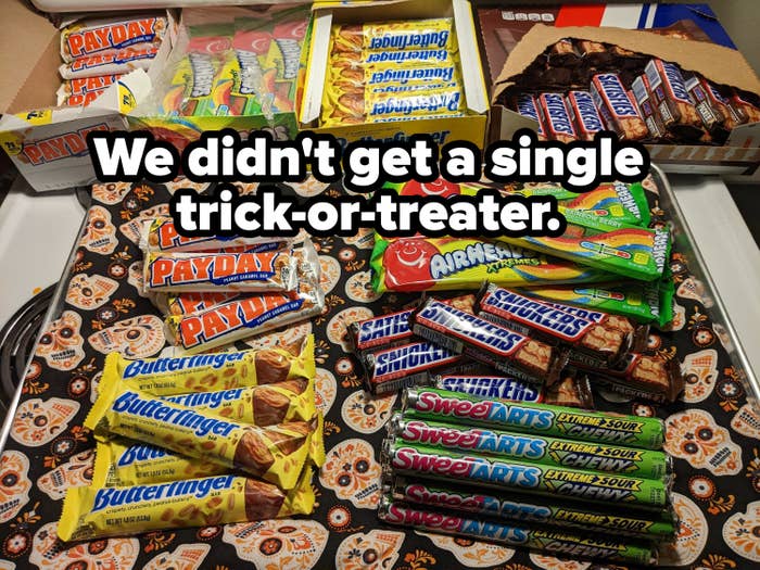 A pile of candy, and boxes of it in the background, with the caption &quot;We didn&#x27;t get a single trick-or-treater&quot;