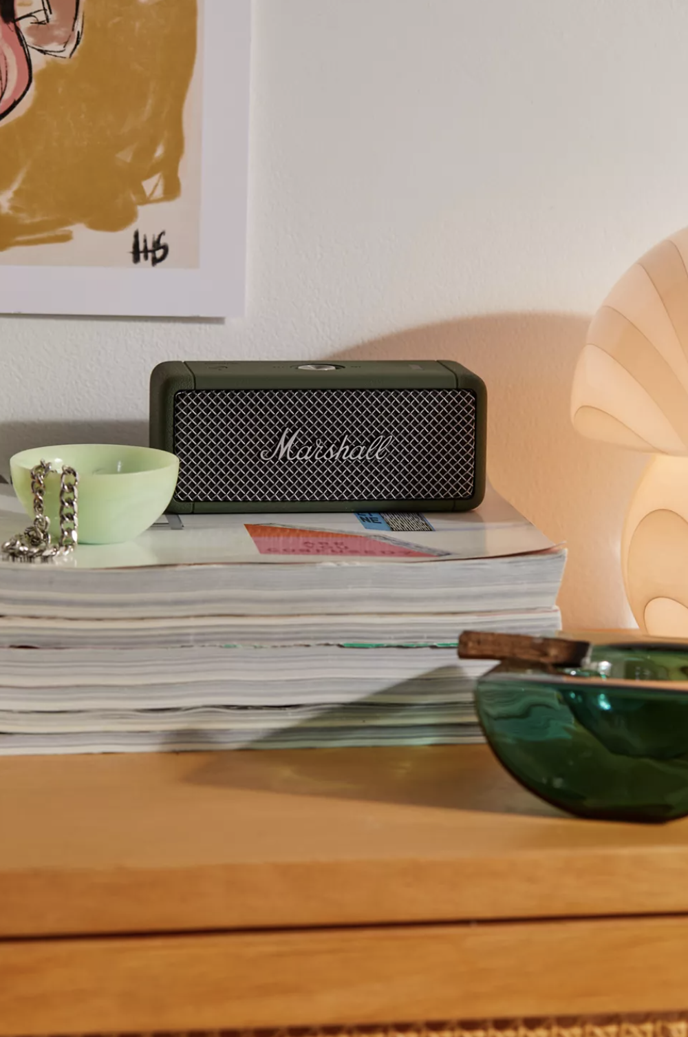 The Green Marshall speaker sits atop some magazines on a side table