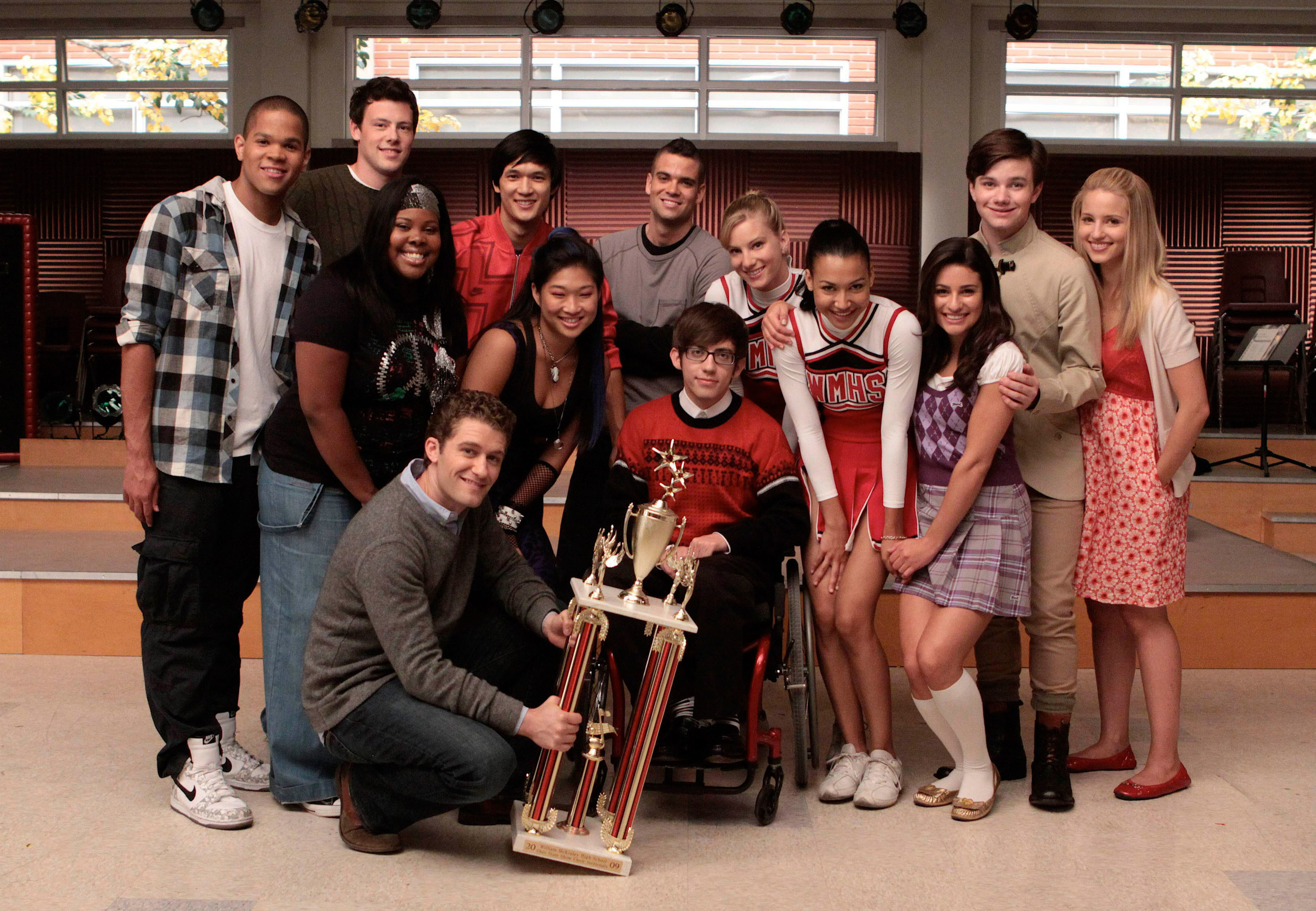 cast members on the show posing with their Glee trophy