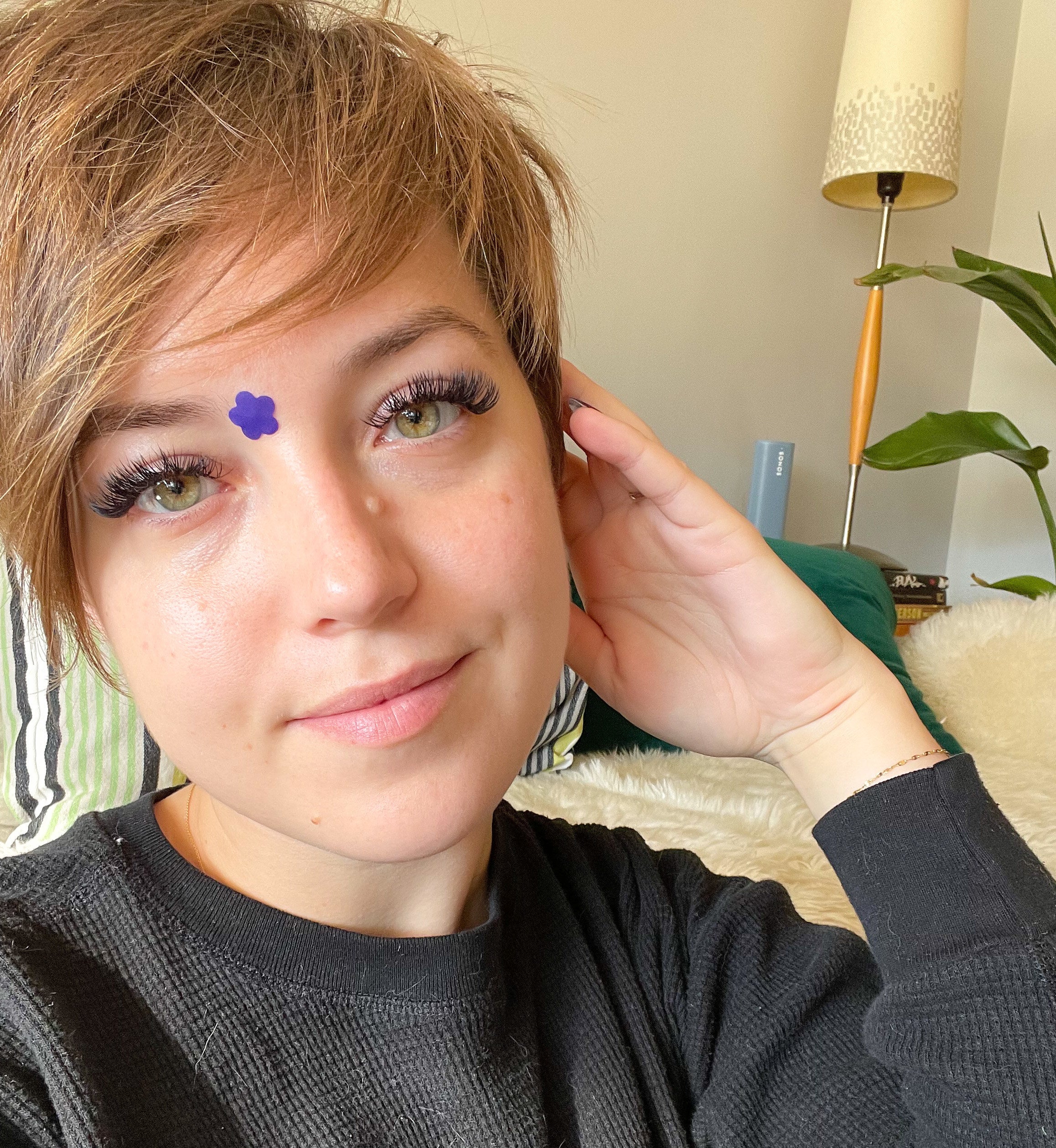buzzfeed writer wearing one of the flower shaped patches on her forehead