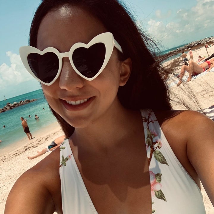 reviewer in the white heart shaped sunglasses at the beach