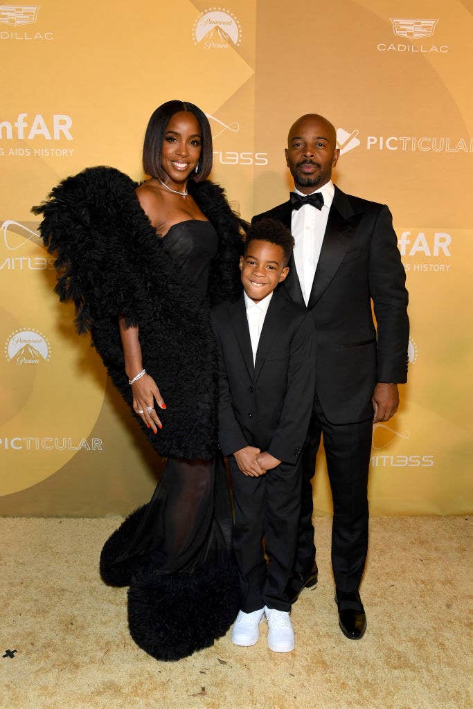 Kelly wore a strapless dress with a see-through bottom and her son and husband wore suits