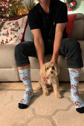 a reviewer wearing the socks with their dog's face on them