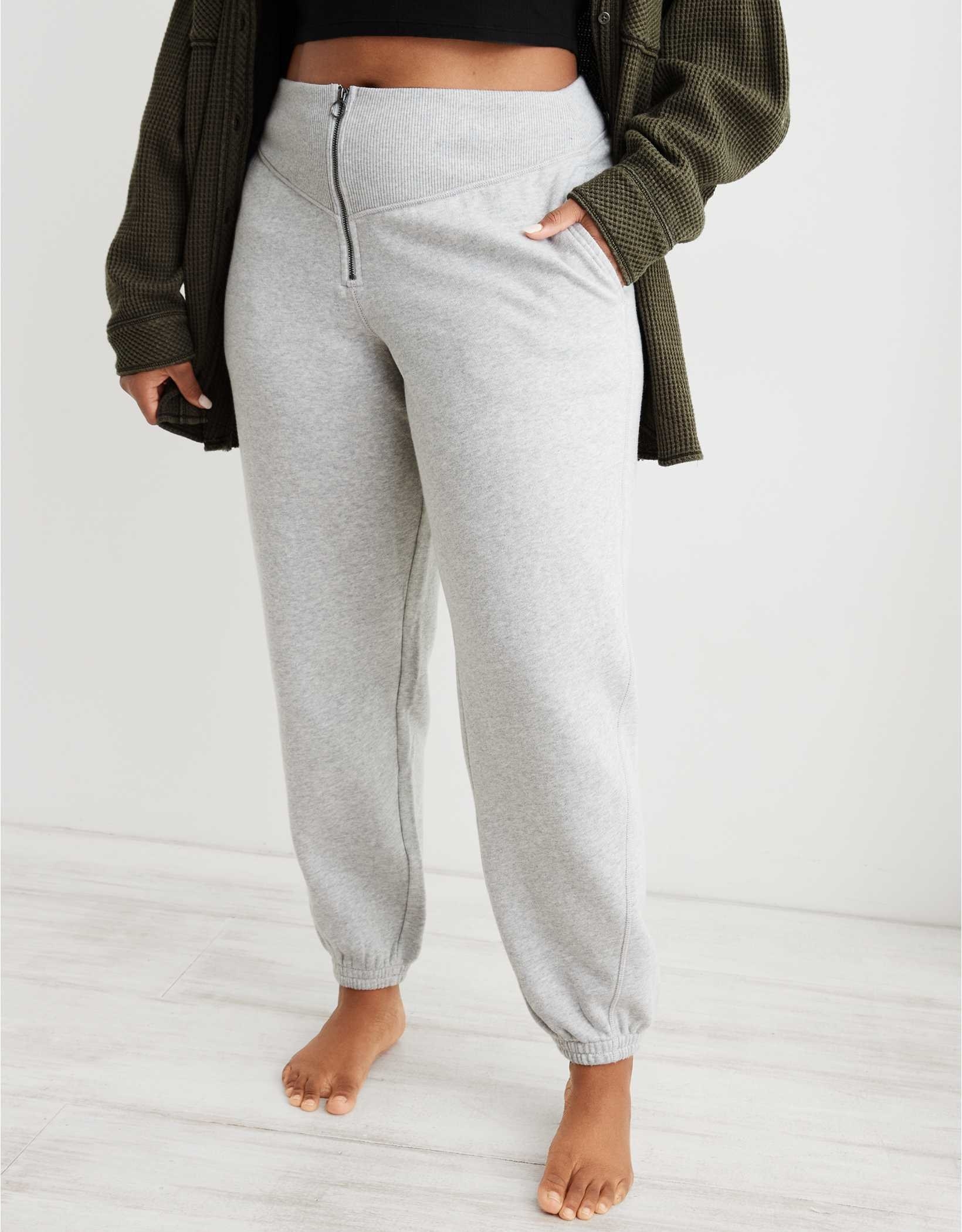 model in light grey joggers with a zipper closure