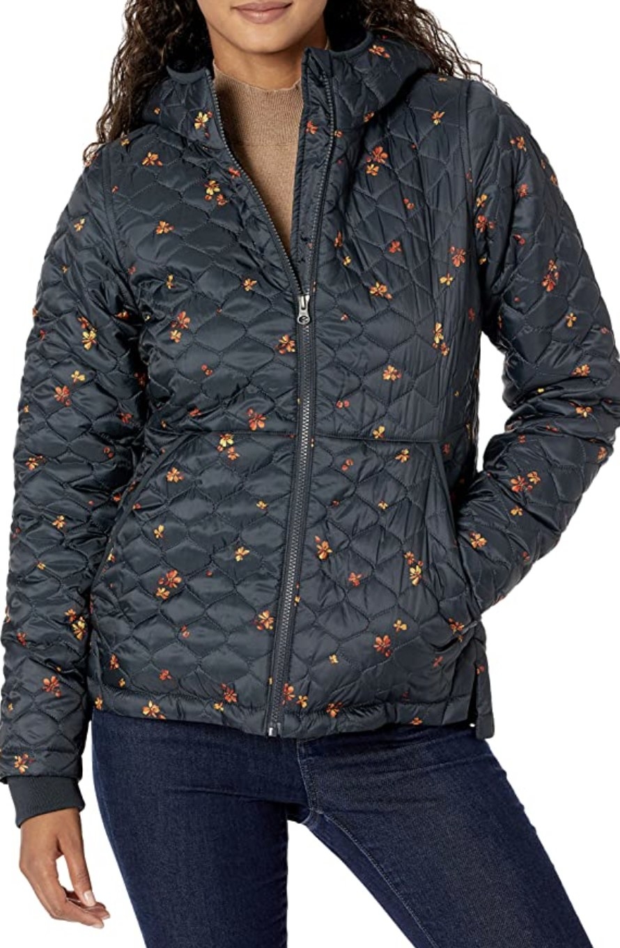Model in the black puffer coat with small flower designs on it
