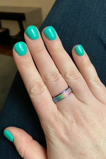 a hand with the rainbow ring on it