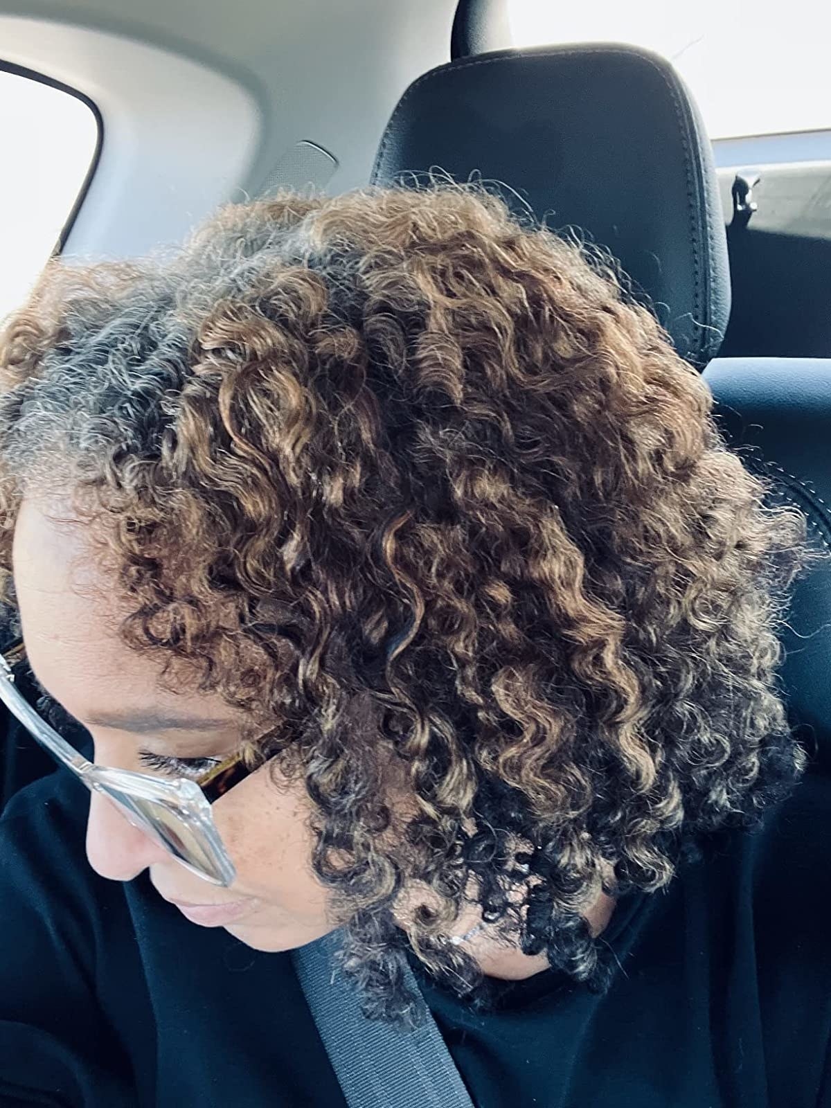 A close-up of a reviewer's curls