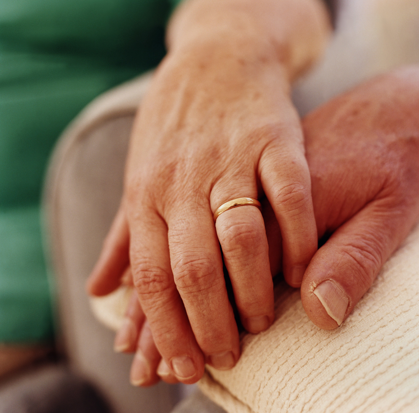 A person with their hand over their partner&#x27;s hand