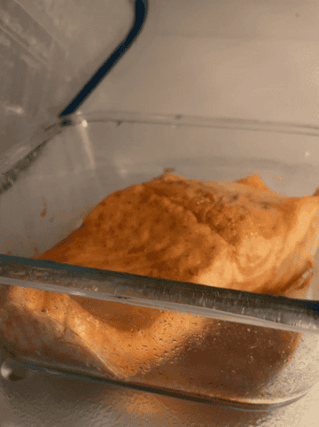 cooked salmon with bubbling sauce in microwave