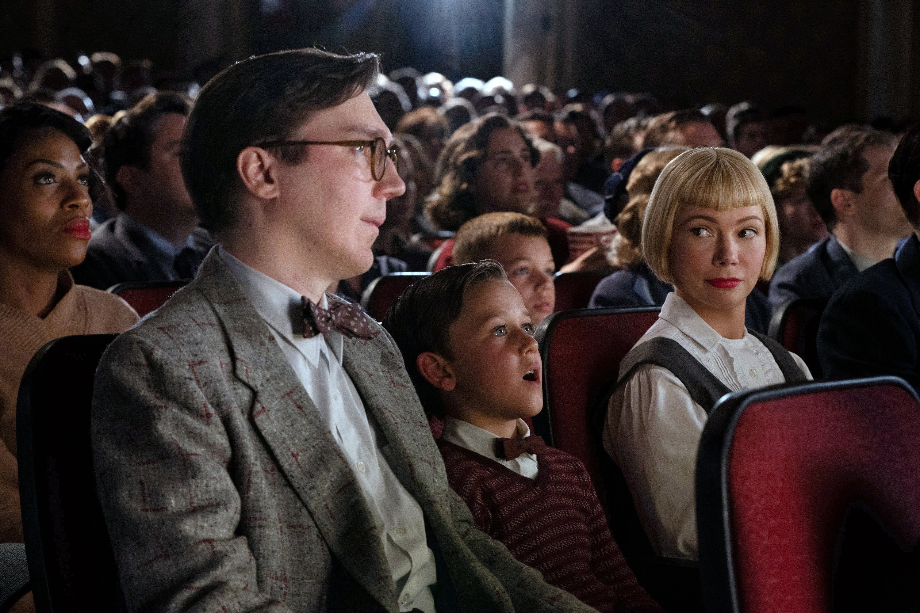 Paul Dano, Mateo Zoryon Francis-DeFord, and Michelle Williams sit in movie theater chairs
