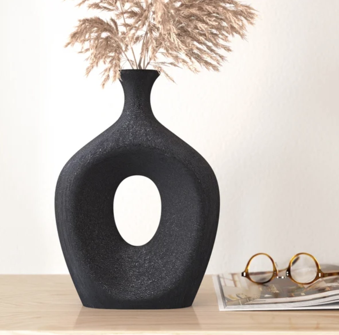 The black vase has inset inner oval