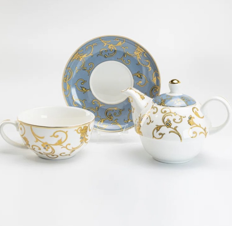 The set has a blue and gold plate and a gold teacup and blended teapot